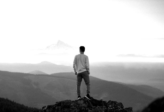 man standing on top of mountain
